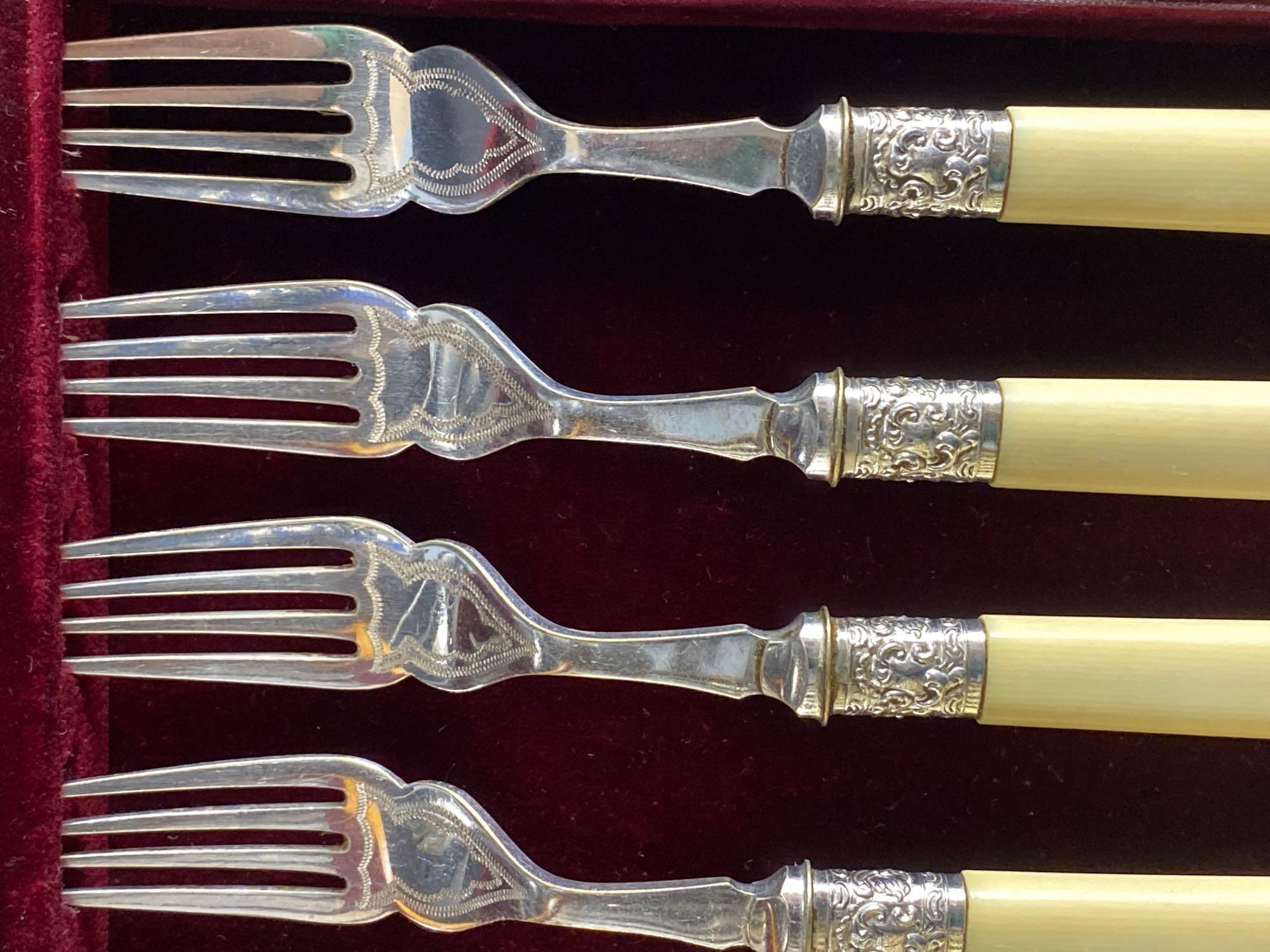 A Victorian rosewood cased set of eighteen plated dessert knives and forks, and two other cased sets of plated cutlery